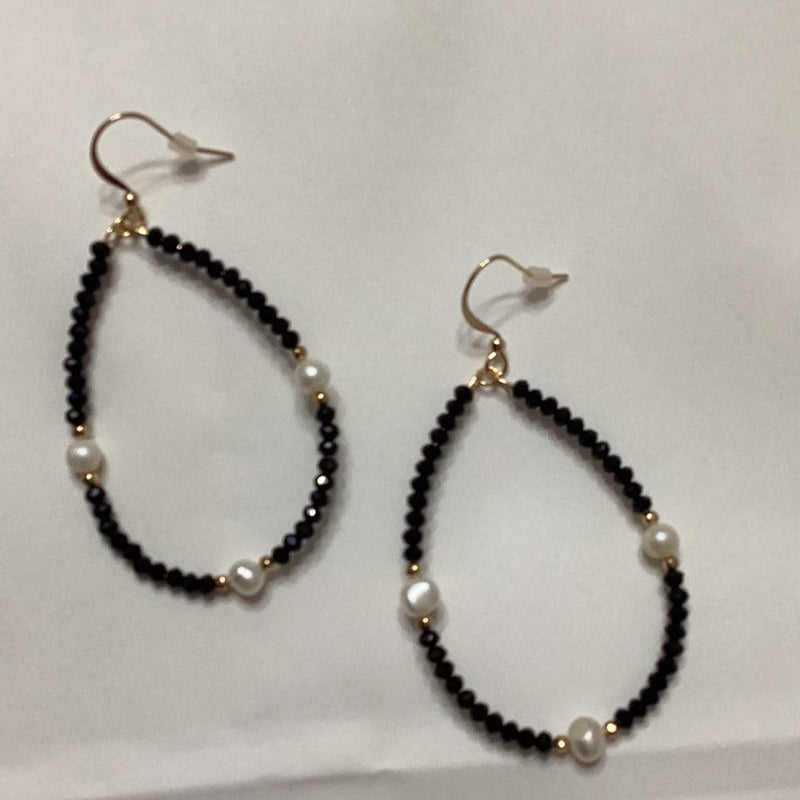 Black and pearl earrings Teardrop-shaped earrings Dangle teardrop earrings Elegant black and pearl drops Pearl teardrop jewelry Stylish teardrop earrings Classic black and pearl earrings Pearl-studded teardrop earrings Black and white teardrop earrings Chic teardrop dangle earrings Timeless pearl drops Sophisticated black and pearl jewelry Teardrop-shaped pearl earrings Pearl accent dangle earrings Contemporary black and pearl drops
